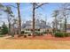 Inviting two-story home featuring manicured landscaping, a front porch and a neutral exterior with dark green shutters at 2290 Spencers Way, Stone Mountain, GA 30087