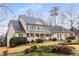 Charming two-story home with a welcoming front porch, green shutters, and beautifully landscaped yard at 2290 Spencers Way, Stone Mountain, GA 30087