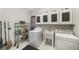 A functional laundry room with a washer, dryer, sink, and overhead cabinetry for storage at 2290 Spencers Way, Stone Mountain, GA 30087