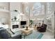 Bright living room featuring tall windows, a fireplace, and neutral décor, creating a comfortable and inviting atmosphere at 2290 Spencers Way, Stone Mountain, GA 30087