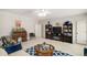 A well-lit living room featuring carpet, couches, two coffee tables, a bookcase, and built-ins at 2290 Spencers Way, Stone Mountain, GA 30087