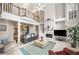 Spacious living room with a fireplace, high ceilings, large windows, and elegant decor, perfect for entertaining at 2290 Spencers Way, Stone Mountain, GA 30087