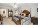 An elegant main bedroom featuring a beautiful four-poster bed, ceiling fan, and access to the main bath at 2290 Spencers Way, Stone Mountain, GA 30087