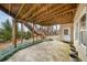 Covered patio featuring stairs to upper level, concrete flooring, and verdant ground cover at 2290 Spencers Way, Stone Mountain, GA 30087