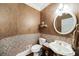 Charming powder room with decorative wallpaper, pedestal sink, and decorative mirror at 2290 Spencers Way, Stone Mountain, GA 30087