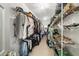 A large walk-in closet with ample storage space with racks for clothing and shelves for shoes and accessories at 2290 Spencers Way, Stone Mountain, GA 30087
