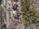 Aerial view of home nestled in a wooded area, with a long driveway at 2311 Shoreline Pkwy, Villa Rica, GA 30180