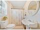 Basement bathroom with pedestal sink, shower, and large mirror at 2311 Shoreline Pkwy, Villa Rica, GA 30180