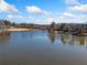 Aerial view of a peaceful lake with houses along the shore at 2311 Shoreline Pkwy, Villa Rica, GA 30180