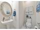 Charming powder room with pedestal sink and storage at 2311 Shoreline Pkwy, Villa Rica, GA 30180