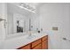 Bathroom vanity with mirror and wood cabinets at 3040 Peachtree Rd # 614, Atlanta, GA 30305