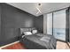 Bedroom with dark walls, hardwood floors, and balcony access at 3040 Peachtree Rd # 614, Atlanta, GA 30305