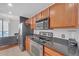 Modern kitchen with stainless steel appliances and wood cabinets at 3040 Peachtree Rd # 614, Atlanta, GA 30305