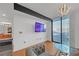 Bright living room with hardwood floors and large TV at 3040 Peachtree Rd # 614, Atlanta, GA 30305