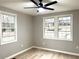 Bedroom features hardwood floors, grey walls, and three windows that let in plenty of natural light at 5091 Newark Ave, Clarkdale, GA 30111