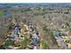 A high-angle aerial view shows the home in its location in a neighborhood bordering a nature area at 1105 River Laurel Dr, Suwanee, GA 30024