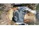 Drone view shows a home with landscaping, a curved driveway and mature trees surrounding the property at 1105 River Laurel Dr, Suwanee, GA 30024
