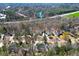 The aerial view offers a wide perspective, showing how the home blends into its surrounding lush environment at 1105 River Laurel Dr, Suwanee, GA 30024