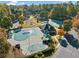 Aerial view of community pool, tennis courts, and playground surrounded by lush foliage at 1105 River Laurel Dr, Suwanee, GA 30024