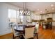 Bright dining area with hardwood floors, large windows, and a kitchen view at 1105 River Laurel Dr, Suwanee, GA 30024