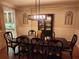 Sophisticated dining area showcasing a dark wood table, custom wall decor, and hardwood floors at 1105 River Laurel Dr, Suwanee, GA 30024