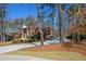 Brick home with an attached garage, long driveway, and well-maintained landscaping at 1105 River Laurel Dr, Suwanee, GA 30024