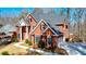 A two-story brick home boasting mature trees and manicured landscaping for ideal curb appeal at 1105 River Laurel Dr, Suwanee, GA 30024