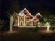 Elegant brick home decorated with festive holiday lights and a well-manicured lawn at 1105 River Laurel Dr, Suwanee, GA 30024