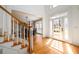 Bright foyer with hardwood floors, staircase, and glass-paned front door at 1105 River Laurel Dr, Suwanee, GA 30024