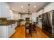 Well-lit kitchen featuring white cabinets, stainless steel appliances, and hardwood floors at 1105 River Laurel Dr, Suwanee, GA 30024