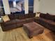 Spacious living room with a sectional sofa, ottoman and large windows offering natural light at 1105 River Laurel Dr, Suwanee, GA 30024