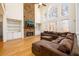 Open concept living room featuring a stone fireplace, large windows, and hardwood floors at 1105 River Laurel Dr, Suwanee, GA 30024