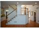 Open staircase leading to the upper level with hardwood floors and abundant natural light at 1105 River Laurel Dr, Suwanee, GA 30024