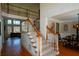 Elegant staircase with wood and white trim leading to the second level of the home at 1105 River Laurel Dr, Suwanee, GA 30024