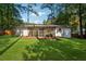 Spacious backyard with grassy area and screened porch at 1464 Sanden Ferry Dr, Decatur, GA 30033