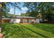 Large backyard with lush lawn and screened porch at 1464 Sanden Ferry Dr, Decatur, GA 30033