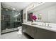 Elegant bathroom with double vanity, walk-in shower, and marble floors at 1464 Sanden Ferry Dr, Decatur, GA 30033