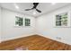 Charming bedroom with hardwood floors, two windows, and ceiling fan at 1464 Sanden Ferry Dr, Decatur, GA 30033