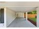 Covered carport with concrete flooring and wooden fence at 1464 Sanden Ferry Dr, Decatur, GA 30033