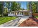 Newly renovated Ranch home with a modern front door and driveway at 1464 Sanden Ferry Dr, Decatur, GA 30033