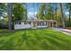 Newly renovated Ranch home with a modern front door and landscaped lawn at 1464 Sanden Ferry Dr, Decatur, GA 30033