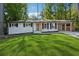 Newly renovated Ranch home with a modern front door and landscaped lawn at 1464 Sanden Ferry Dr, Decatur, GA 30033