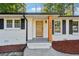 Modern front door with wood accents and brick facade at 1464 Sanden Ferry Dr, Decatur, GA 30033