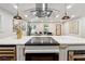 Modern kitchen island with built-in cooktop and range hood at 1464 Sanden Ferry Dr, Decatur, GA 30033