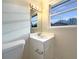 Bright bathroom with single sink vanity and updated fixtures at 24 Valerie Ln, Powder Springs, GA 30127