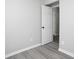 This bedroom features gray walls, wood floors, and a white door at 7015 Setters Way, Lithonia, GA 30038