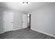 Bedroom featuring neutral walls, wood flooring, and closet doors at 7015 Setters Way, Lithonia, GA 30038