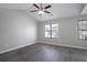 Bright bedroom with vaulted ceiling, ceiling fan, wood-look flooring, and natural light at 7015 Setters Way, Lithonia, GA 30038