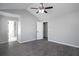 Spacious bedroom featuring wood-look floors, neutral walls, and access to the bathroom and closet at 7015 Setters Way, Lithonia, GA 30038