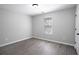 Cozy bedroom featuring neutral walls, wood flooring, and a window for natural light at 7015 Setters Way, Lithonia, GA 30038